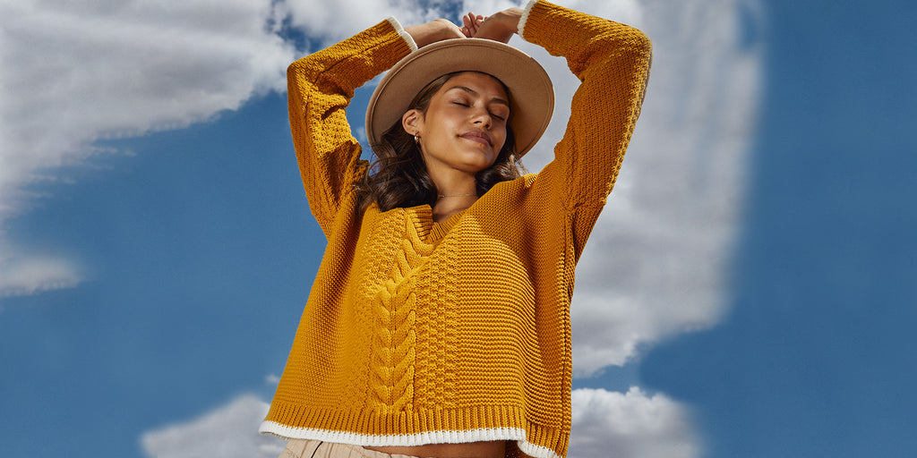 Woman blue sky background and yellow jumper