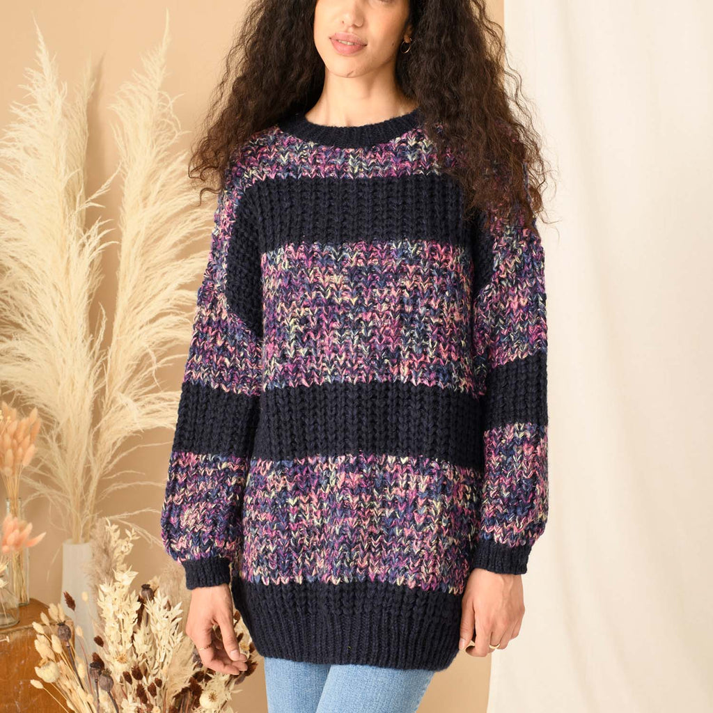 Close up of a woman wearing a navy blue striped knitted jumper