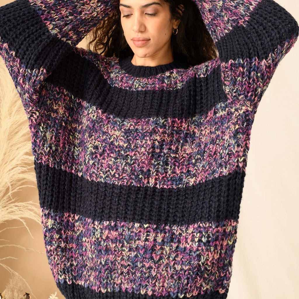 Close up of woman wearing a knitted blue chunky stripe jumper